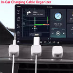 White magnetic cable clips organizing charging cables in a car